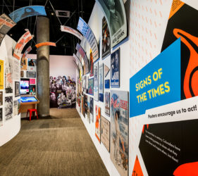 Hall of colorful posters with graphics curving inward overhead